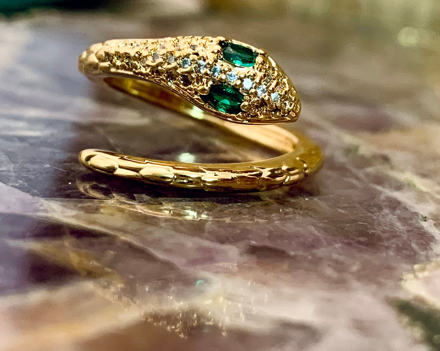 Gold snake ring with green best sale eyes